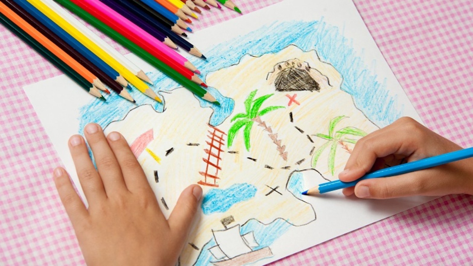 A child draws a treasure map.