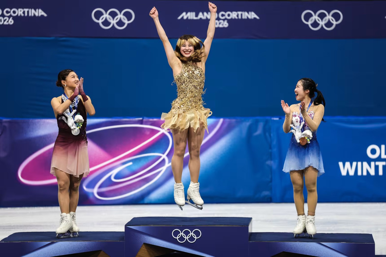 Liu, the gold medalist, and silver medalist Kaori Sakamoto and bronze medalist Ami Nakai of Japan celebrate on the podium during the medal ceremony. Image: Jamie Squire / Getty Images