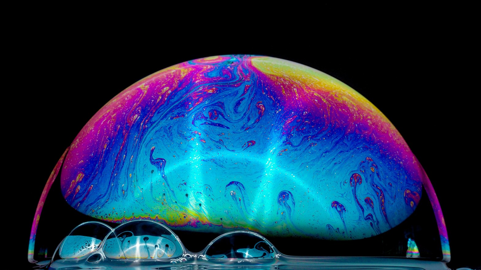 Close-up photo of a soap bubble with a black background